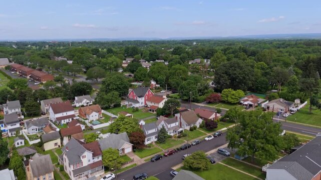 Row of houses along street in neighborhood of American town. Sunny day in small town of Bethlehem, Pennsylvania. aerial forward shot.