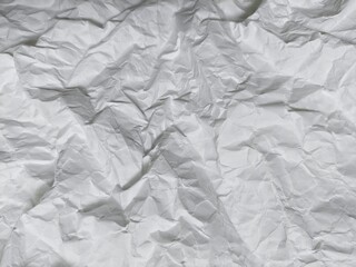 Obraz premium Crumpled white paper texture background with wavy surface. Crumpled white vintage paper surface texture for background. Wrinkled paper, abstract background. Paper background with copy space for text.