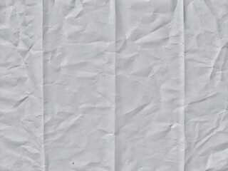 Crumpled white paper texture with fold lines. Crumpled blank white paper folded in four fraction...