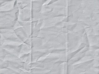 Crumpled white paper texture with fold lines. Crumpled blank white paper folded in three fraction...