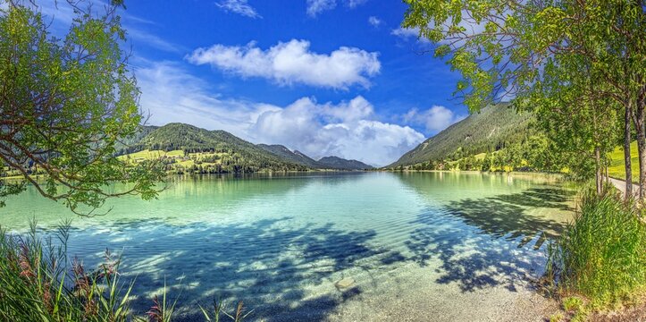 Weissensee shoreline with reeds and alpine view