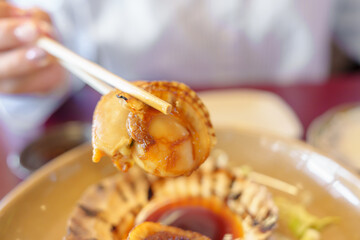 grilled Scallop in Matsushima fish market, seafood famous and popular of Matsushima bay in Miyagi Prefecture, Tohoku, Japan