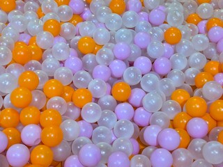 photo of ball pit, playground, bubble, colorful background, orange, purple, white, pearl, plastel