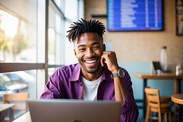 Happy african american man working on laptop in cafe, smiling and feeling successful