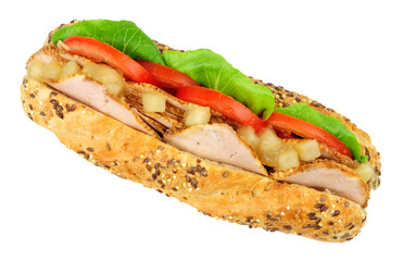 Roast pork loin and salad sandwich with chunky apple sauce in a multi seed baguette bread roll isolated on a white background