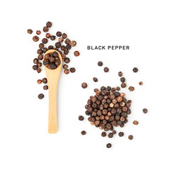 Black peppercorns in wooden spoon and heap photography isolated on white background