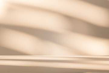 Wall interior background, studio and backdrops show products. with leaf shadow from window color beige and white. background for text insertion and presentation of product	
