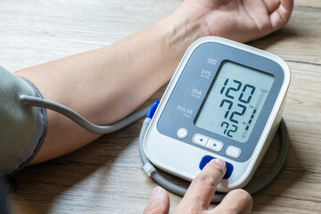 Man check blood pressure monitor and heart rate monitor with digital pressure gauge. Health care and Medical concept
