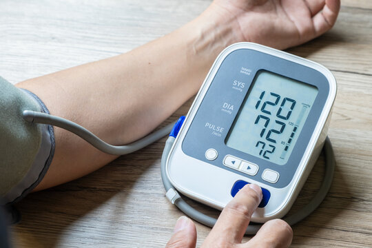 Man check blood pressure monitor and heart rate monitor with digital pressure gauge. Health care and Medical concept	
