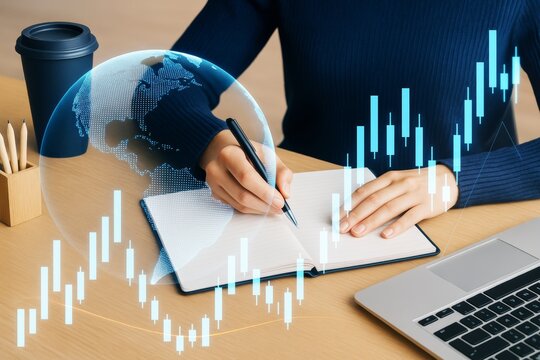 Businesswoman writing in notebook with digital stock market chart and globe hologram on light wood background, business strategy concept.