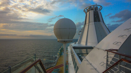 Outdoor promenade boat sun deck onboard modern luxury cruiseship cruise ship liner with loungers...
