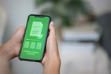 Document verification success on smartphone screen in hand