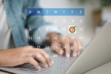 User typing on laptop with digital calendar and target schedule