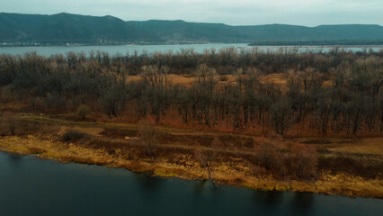 Fototapeta premium River bank scene : Aerial view of river and forest with natural scene in a serene landscape. The Volga River in Russia, Samara Region