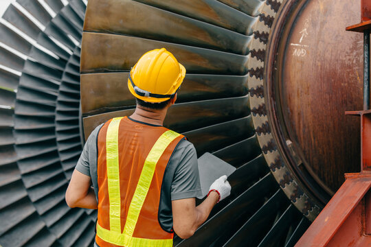 Professional Asian engineer male working service power plant turbine fan blade electrical generator