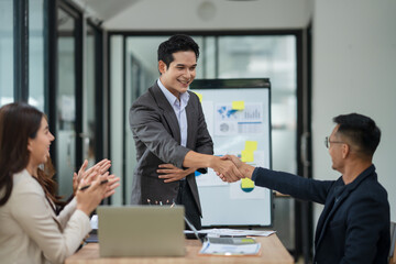 Asian business group is happy to join hands to show success in their careers.	
