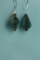 Green teal Christmas paper toys as flashlight on paper textured background, Scandinavian Christmas...