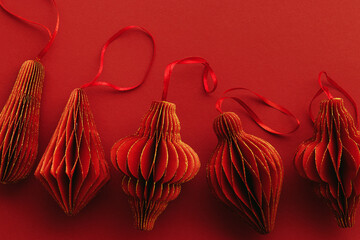 Shiny Red Paper Christmas Ornaments, winter seasonal holiday decorations on red background,...