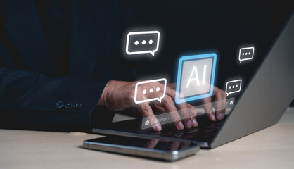 A person types on a laptop with AI and speech bubble icons floating, symbolizing artificial...