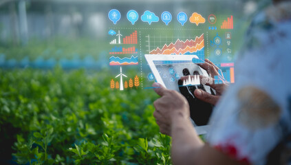 A person uses a tablet with digital agricultural data overlays in a green field, illustrating smart...