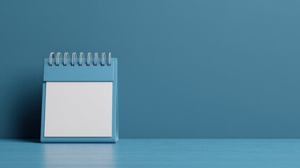 Conscious consumerism concept, Blank calendar on a blue surface, offering a minimalist design for scheduling or planning.