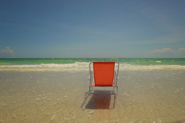 Behind orange chair in sand Gulf of Mexico Anna Maria Island