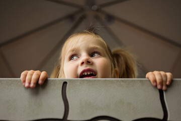 Education and parenting, close-up little girl's face