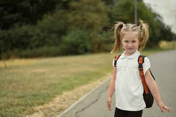 Little 5 years girl with backpack going to school, copy space
