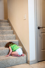 Female child asleep on stairs in diaper