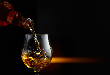 Brandy being poured into a glass.