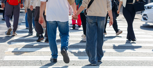 A couple is walking across a busy street