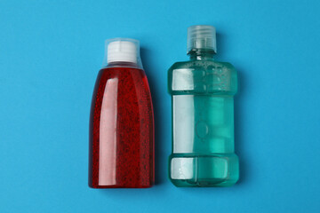 mouthwash, toothbrush, dental care tools on blue background
