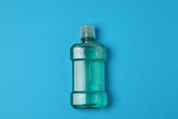 mouthwash, toothbrush, dental care tools on blue background
