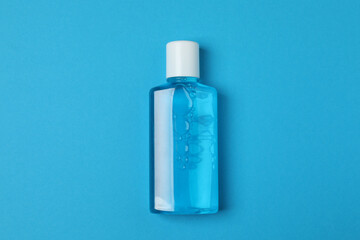 mouthwash, toothbrush, dental care tools on blue background
