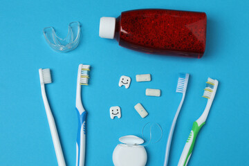 mouthwash, toothbrush, dental care tools on blue background
