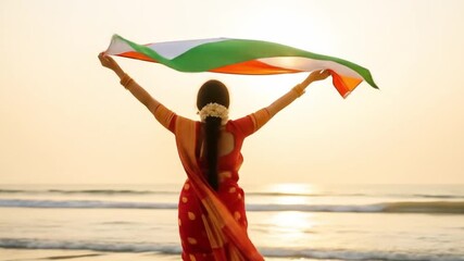 Smiling woman proudly holds Indian flag at beach. Suitable for patriotic and travel themed designs, advertisements, and social media posts.