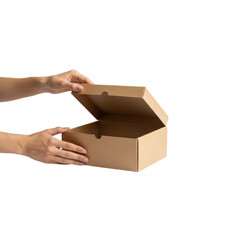 A pair of hands carefully opens a plain brown cardboard box with its lid lifted on a
