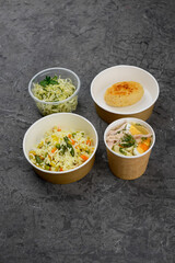 lunch soup, rice with vegetables and a cutlet with coleslaw in a disposable container