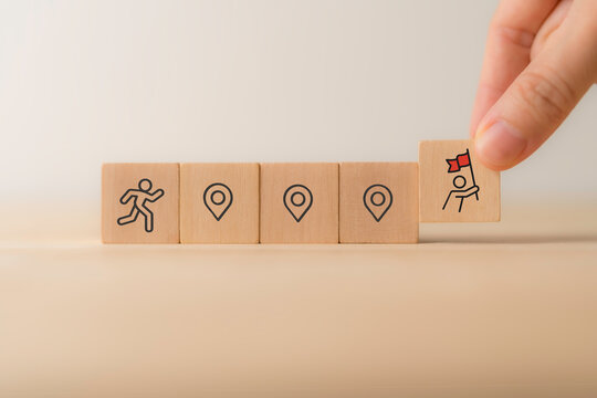 Career Path and Development Strategy Concept. Arranging wooden blocks with icons success roadmap and journey, symbolizing a structured career path and strategic development. Planning, growth, progress