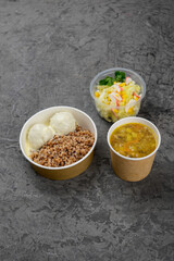 lunch soup with vegetables buckwheat with meatballs and salad on a gray background