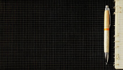 Gridded notebook and pen on dark surface