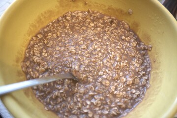 Chocolate porridge for breakfast in a yellow bowl