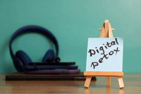 Digital detox concept featuring sticky note, headphones, and smartphone