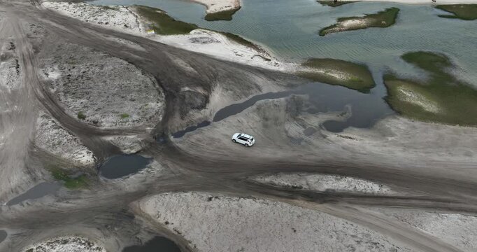 Above View Of 4x4 Vehicles Exploring The Sand Dunes In Jericoacoara, Brazil. Aerial Drone Shot