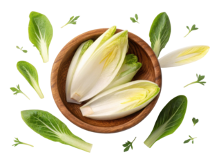 Fresh endive leaves arranged beautifully in wooden bowl surrounded by vibrant greens create delightful and healthy display
