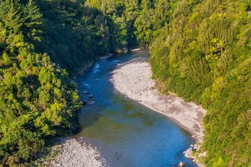 Serene river meandering through lush forest.