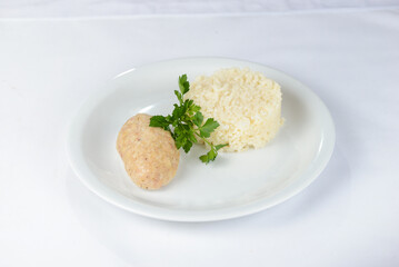 rice with fish cutlet on a white plate