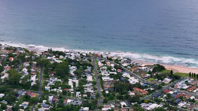 South Coast, NSW, Australia: Drone UHD Video -Sweeping along the beach on Thirroul coastline, a small resort town with pretty beaches, colonial streetscapes, mining heritage and incredible bushwalks.