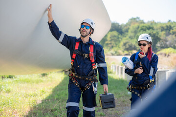 Engineer team working maintenance wind turbine farm.