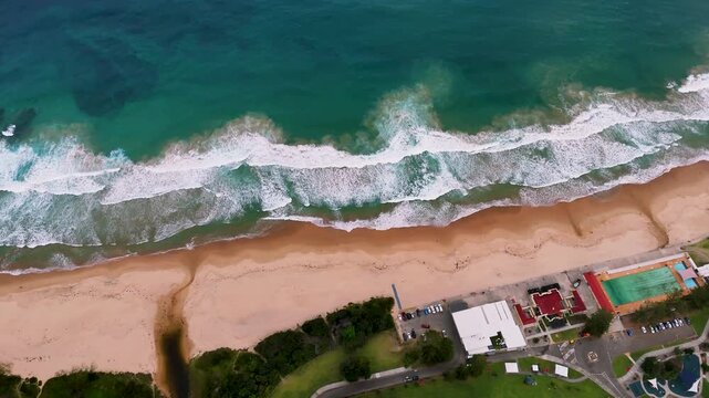 South Coast, NSW, Australia: Drone UHD Video -Magnificent Panoramic Views of the Coastline, starting from the foaming green-blue waves on the beach to Bulli mountain range and the pretty resort towns.